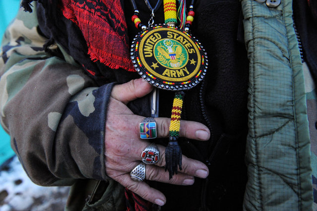 Steve Perry from the Odawa tribe displays his Army medal for the camera in Oceti Sakowin camp as “water protectors” continue to demonstrate against plans to pass the Dakota Access pipeline near the Standing Rock Indian Reservation, near Cannon Ball, North Dakota, U.S. December 3, 2016. (Photo by Stephanie Keith/Reuters)