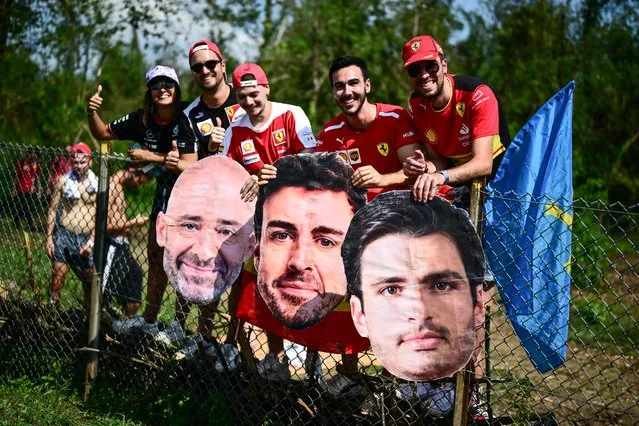 Fans pose with placard portraits of Aston Martin's Spanish driver Fernando Alonso (C) and Ferrari's Spanish driver Carlos Sainz Jr (R) during third practice session, ahead of the Italian Formula One Grand Prix at Autodromo Nazionale Monza circuit, in Monza on September 2, 2023. (Photo by Marco Bertorello/AFP Photo)