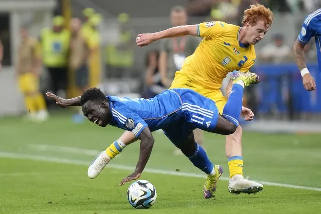 Italy's Wilfried Gnonto, left, is fouled by Ukraine's Yukhym Konoplia during the Euro 2024 group C qualifying soccer match between Italy and Ukraine at the San Siro stadium, in Milan, Italy, Tuesday, September 12, 2023. (Photo by Luca Bruno/AP Photo)