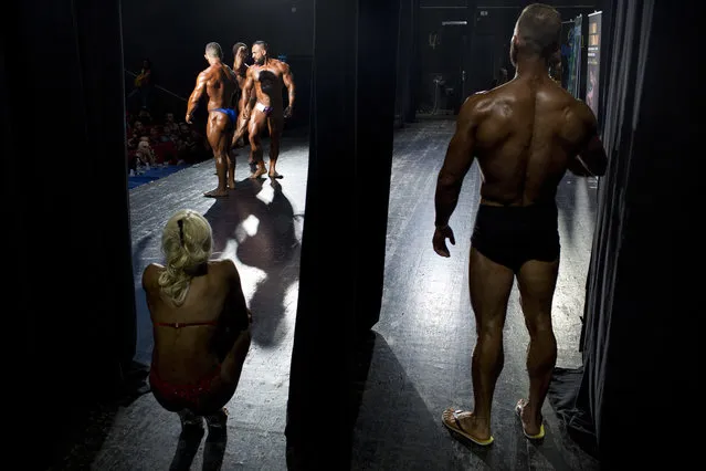 In this Thursday, October 18, 2018 photo, contestants participate in the final round during the National Amateur Body Builders' Association competition in Tel Aviv, Israel. (Photo by Oded Balilty/AP Photo)