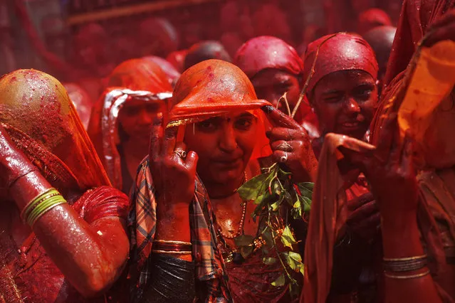 Women hold their veils as they take part in “Huranga” at the Dauji temple near the northern Indian city of Mathura, March 7, 2015. (Photo by Adnan Abidi/Reuters)