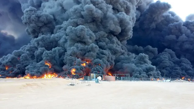 Smoke rises from burning oil storage tanks in the port of Ras Lanuf, Libya, January 23, 2016. (Photo by Reuters/Stringer)