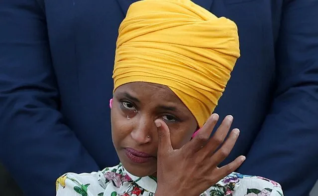 Rep Ilhan Omar (D-MN) wipes her tears as members of Congress observe a moment of silence for the 600,000 American lives lost to the coronavirus disease (COVID-19), outside the U.S. Capitol in Washington, U.S., June 14, 2021. (Photo by Evelyn Hockstein/Reuters)