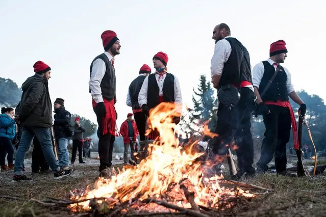 “Galejadors” (flaunters) light bonfires to prepare breakfast in the forest during “La Festa del Pi” (The Festival of the Pine) in the village of Centelles on December 30, 2016 near to Barcelona. (Photo by Josep Lago/AFP Photo)