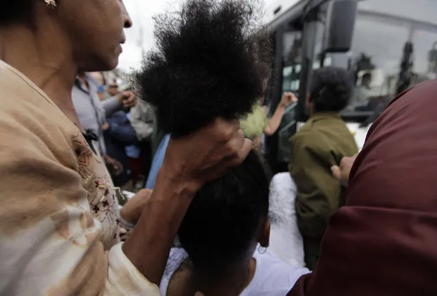 Security forces drag members of the Ladies in White, a group made up of family members of imprisoned dissidents, into a bus after a march in Havana, Cuba, March 2010. (Photo by Desmond Boylan/Reuters)