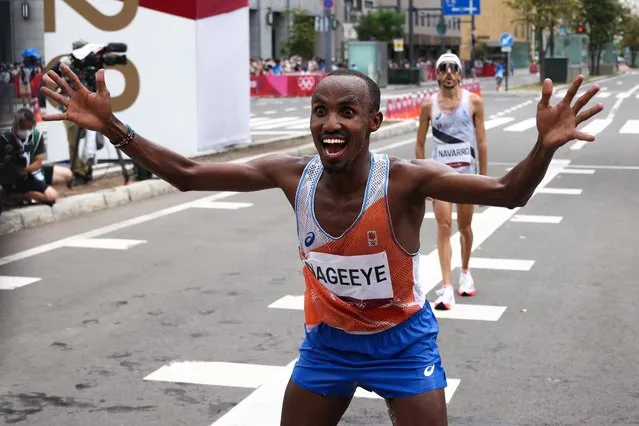 Second-placed Netherlands' Abdi Nageeye reacts as he arrives at the finish line in the men's marathon final during the Tokyo 2020 Olympic Games in Sapporo on August 8, 2021. (Photo by Kim Hong-Ji/Reuters)