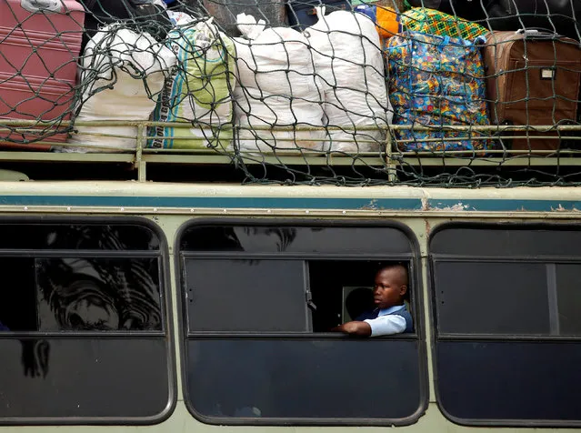 A child sits inside a bus on its way to a boarding school on the opening day of the new school term in Mbare township, Harare, Zimbabwe, January 9, 2018. (Photo by Philimon Bulawayo/Reuters)