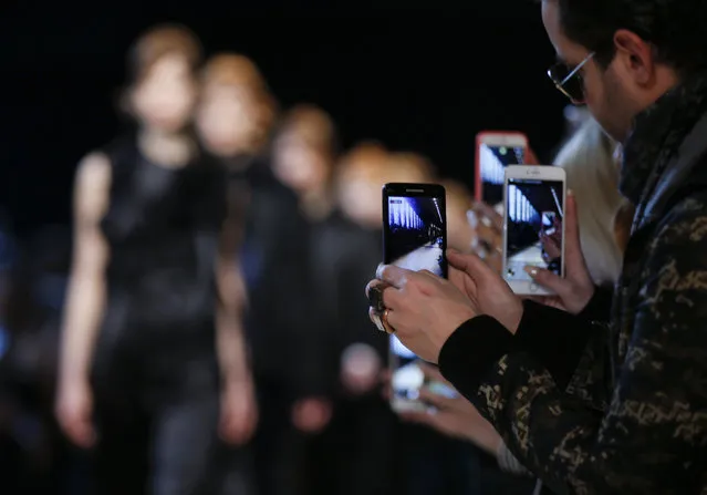 Guests film models with their smart phones during the Costume National women's Fall-Winter 2016-2017 collection, part of the Milan Fashion Week, unveiled in Milan, Italy, Thursday, February 25, 2016. (Photo by Luca Bruno/AP Photo)