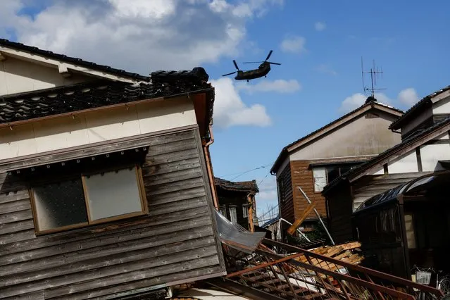 Japan Self-Defense Forces helicopter flies over an affected area, in the aftermath of an earthquake, in Wajima, Ishikawa Prefecture, Japan on January 4, 2024. (Photo by Kim Kyung-Hoon/Reuters)