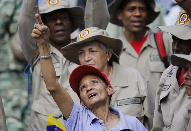 Supporters of President Nicolas Maduro sing a song about Venezuela's late president Hugo Chavez, during a event at Bolivar Square in Caracas, Venezuela, Thursday, February 7, 2019. Maduro said that he hopes to collect 10 million signatures to ask Washington to withdraw its threats of war against the people of Venezuela. (Photo by Ariana Cubillos/AP Photo)