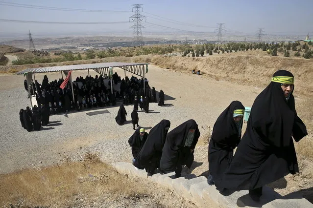 In this Thursday, August 22, 2013 photo, female members of the Basij paramilitary militia attend a training session in Tehran, Iran. (Photo by Ebrahim Noroozi/AP Photo)