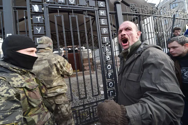A protester shouts in front of the Russian embassy in Kiev on March 6, 2016, during a rally to support and demand the release from jail of the hunger-striking Ukrainian pilot Nadiya Savchenko. The pilot, who this week rejected food and water to protest delays in her controversial murder trial in Russia, is in “satisfactory condition”, her lawyer said on March 6. (Photo by Sergei Supinsky/AFP Photo)