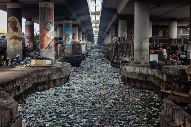 A general view of a clogged up canal filled with styrofoam and single use plastic at Obalende in Lagos on January 23, 2024. (Photo by Benson Ibeabuchi/AFP Photo)