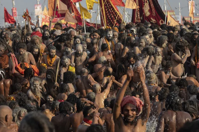 In this Tuesday, January 15, 2019 photo, sadhus, Hindu holy men, take a holy dip at Sangam, the confluence of the rivers Ganges, Yamuna and mythical Saraswati, during the Kumbh Mela festival in Prayagraj, India. The city's Mughal-era name Allahabad was recently changed to Prayagraj by the Hindu nationalist government. The historic city name referred to Muslim Mughal rulers during the 16th century. The new name refers to the confluence of the rivers Ganges, Yamuna and mythical Saraswati, the site of the Hindu Kumbh Mela festival. (Photo by Bernat Armangue/AP Photo)