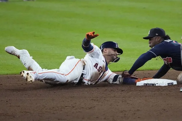 Atlanta Braves second baseman Ozzie Albies tags out Houston Astros' Yuli Gurriel at second during the eighth inning of Game 1 in baseball’s World Series between the Houston Astros and the Atlanta Braves Tuesday, October 26, 2021, in Houston. (Photo by Sue Ogrocki/AP Photo)