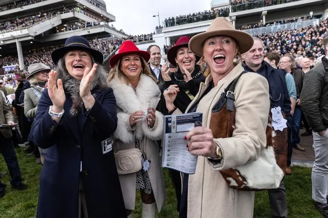 Punters cheer as their horse comes in during the first race of the Cheltenham Festival on Tuesday, March 12, 2024. Reigning champion Galopin Des Champs (“field scamp”) is tipped to gallop to victory again during Friday’s Gold Cup. (Photo by Richard Pohle/the Times)