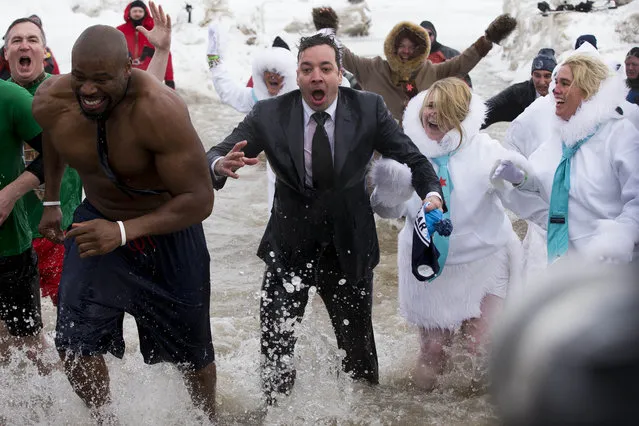 “The Tonight Show” host Jimmy Fallon, center, exits the water during the Chicago Polar Plunge, Sunday, March 2, 2014, in Chicago. Fallon joined Chicago Mayor Rahm Emanuel in the event. (Photo by Andrew A. Nelles/AP Photo)