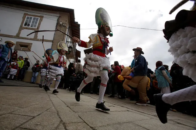 Carnival revellers dressed as “Peliqueiros” run along a street in the village of Laza, Spain February 26, 2017. (Photo by Miguel Vidal/Reuters)