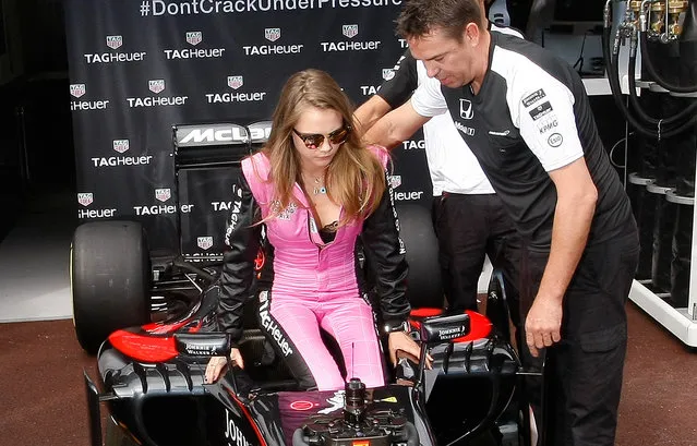 Model Cara Delevingne, left, seats on a McLaren car during a photo call at the McLaren pits prior to the start of the Formula One Grand Prix, at the Monaco racetrack, in Monaco, Sunday, May 24, 2015. (Photo by Claude Paris/AP Photo)