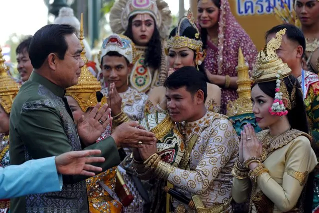 Thailand's Prime Minister Prayuth Chan-ocha greets traditional dancers as he arrives for a weekly cabinet meeting at Government House in Bangkok, Thailand, April 19, 2016. (Photo by Chaiwat Subprasom/Reuters)