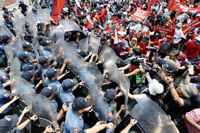 Protesters are blocked by anti-riot police as they march towards the US embassy during a protest rally in Manila, Philippines, 01 May 2024. The protesting group condemned joint exercises by the Philippines and the United States Armed Forces taking place from 22 April to 10 May in the South China Sea. (Photo by Francis R. Malasig/EPA)