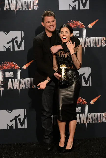 Honoree Channing Tatum (L, holding Trailblazer Award) and actress Jenna Dewan-Tatum pose in the press room during the 2014 MTV Movie Awards at Nokia Theatre L.A. Live on April 13, 2014 in Los Angeles, California. (Photo by Jason Merritt/Getty Images for MTV)
