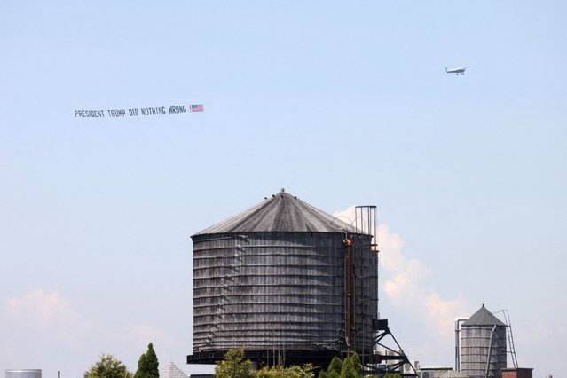 A supporter of former U.S. President Donald Trump flies in a plane with a banner along the Hudson River, as Trump's trial for allegedly covering up hush money payments linked to p*rn star Stormy Daniels before the 2016 presidential election continues, in Manhattan, New York City on May 21, 2024. (Photo by Andrew Kelly/Reuters)