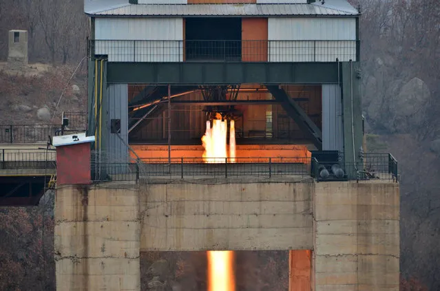 This undated picture released by North Korea's official Korean Central News Agency (KCNA) on March 19, 2017 shows the ground jet test of a newly developed high-thrust engine at the Sohae Satellite Launching Ground in North Korea. North Korea has tested a powerful new rocket engine, state media said on March 19, with leader Kim Jong-Un hailing the successful test as a “new birth” for the nation's rocket industry. (Photo by AFP Photo/KCNA)