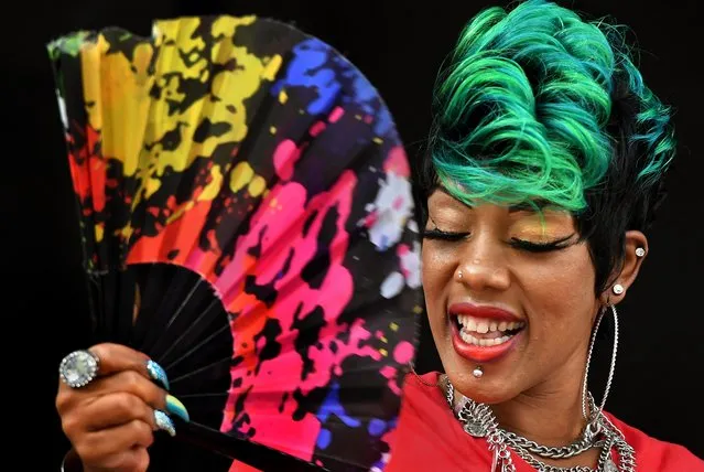 Ashley Brown of the band Bela Dona sings a Go-Go inspired song in Washington, D.C. on August 17, 2019. Her fan was park of her costume but came in handy in the humid heat that hovered over Washington, D.C. today. Chuck Brown Park was the setting for the 5th Annual Chuck Brown Day in NE Washington, D.C. where hundreds attended the party that featured food and lots of music to honor the great local singer, song writer and guitarist. Chuck Brown Day commemorates the life legacy and music of the DC legend – the Godfather of Go-Go. (Photo by Michael S. Williamson/The Washington Post via Getty Images)