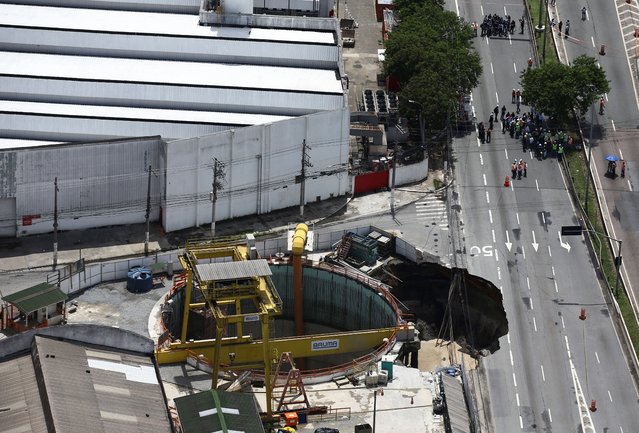 An aerial view shows part of an expressway collapsed above a construction site where Spain's Acciona SA was excavating a tunnel for a new metro line in Sao Paulo, Brazil, February 1, 2022. (Photo by Carla Carniel/Reuters)