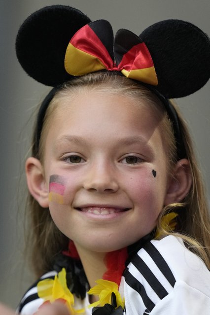 A young German supporter smiles as she waits for the start of the Group A match between Germany and Scotland at the Euro 2024 soccer tournament in Munich, Germany, Friday, June 14, 2024. (Photo by Matthias Schrader/AP Photo)