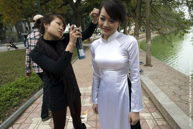 A wedding stylist preps a bride before a wedding photo shoot