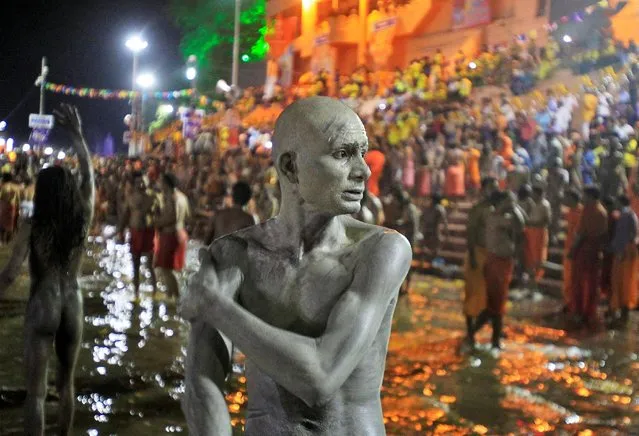 A Sadhu or a Hindu holy man applies ashes on his body after taking a dip in the waters of Shipra river during the second “Shahi Snan” (grand bath) at the Simhastha Kumbh Mela in Ujjain, India, May 9, 2016. (Photo by Jitendra Prakash/Reuters)