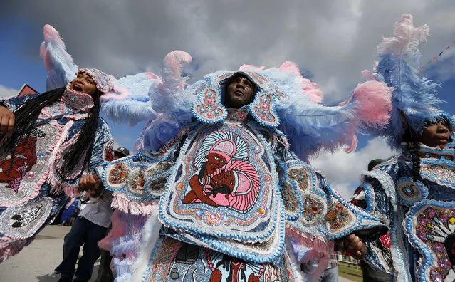 The Cheyenne and 7th Ward Creole Hunters Mardi Gras Indians second line through the crowd at the New Orleans Jazz and Heritage Festival in New Orleans, Thursday, May 4, 2017. (Photo by Gerald Herbert/AP Photo)