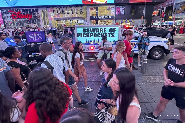 An electronic billboard on an NYPD vehicle notifies visitors to Beware of Pickpockets in Times Square in New York on Sunday, July 21, 2024. (Photo by Ted Shaffrey/AP Photo)