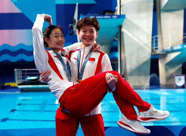 Gold medalists Chang Yani (L) and Chen Yiwen of Team China celebrate during the awarding ceremony after the Women's Synchronised 3m Springboard Final of Diving on Day 1 of the Paris 2024 Olympic Games at the Aquatics Centre on July 27, 2024 in Saint-Denis, France. (Photo by Gonzalo Fuentes/Reuters)