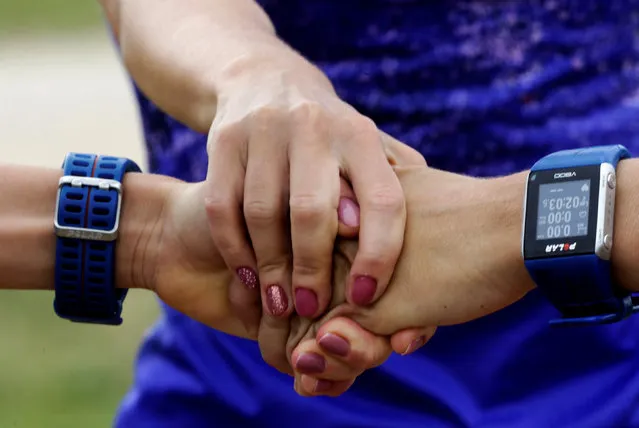 Estonia's olympic team female marathon runners triplets Leila, Liina and Lily Luik hold hands during a training session in Tartu, Estonia, May 26, 2016. (Photo by Ints Kalnins/Reuters)