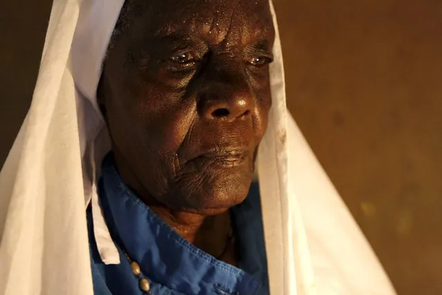 Clementina Auma Ojwang, a religious leader of the Legio Maria, a Spirit Initiated Church, prays for U.S. President Barack Obama's visit in the village of Kogelo, west of Kenya's capital Nairobi, July 15, 2015. Auma, 87, said they are proud of better roads, improved security and greater business opportunities since Obama became President. (Photo by Thomas Mukoya/Reuters)