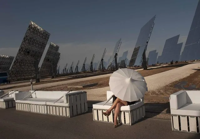 A guest waits for the start of the Summer Fashion show at the Gemasolar solar plant just outside of Seville, Spain, Friday July 17, 2015. (Photo by Laura Leon/AP Photo)