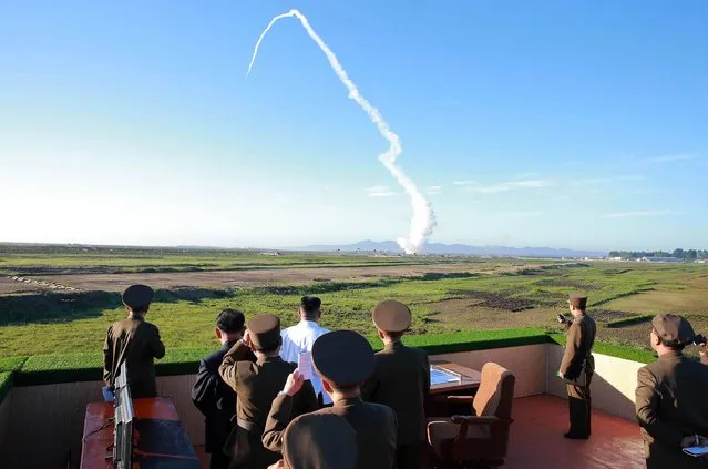 This undated picture released from North Korea's official Korean Central News Agency (KCNA) on May 28, 2017 shows North Korean leader Kim Jong-Un (C-in white shirt) watching the test of a new anti-aircraft guided weapon system organized by the Academy of National Defence Science at an undisclosed location. North Korean leader Kim Jong-Un has overseen a test of a new anti-aircraft weapon system, state media said on May 28, amid mounting tensions in the region following a series of missile tests by Pyongyang. (Photo by AFP Photo/KCNA via KNS)