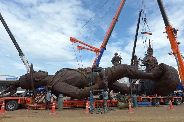 Thai workers prep and install statues of Thai kings at Ratchapakdi Park in Prachuap Khiri Khan province on August 3, 2015. The statues are part of an installation at a park called Ratchapakdi in Hua Hin to honour past Thai monarchs. The park, under construction by the Thai army, honour's the country's royal institution and is located at a military compound near the Klai Kangwon Palace. (Photo by Pornchai Kittiwongsakul/AFP Photo)