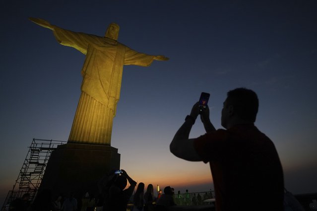 A tourist takes a photo of the Christ the Redeemer statue in Rio de Janeiro, Tuesday, September 10, 2024. (Photo by Hannah-Kathryn Valles/AP Photo)