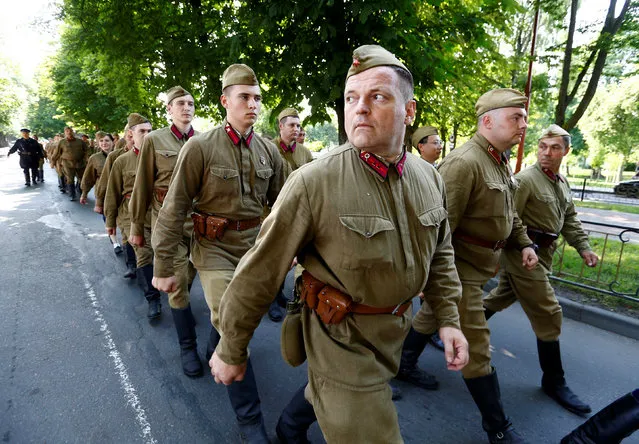 Military enthusiasts dressed as World War Two Red Army soldiers march as they mark the 75th anniversary of the Nazi Germany invasion, in Brest, Belarus, June 21, 2016. (Photo by Vasily Fedosenko/Reuters)