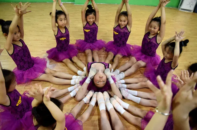 Children do basic training at a children's dance training center on June 26, 2016 in Bozhou, Anhui Province of China. Some Chinese children took interest classes in the summer vocation. (Photo by VCG/VCG via Getty Images)