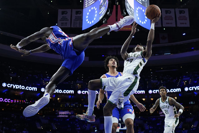 Milwaukee Bucks' AJ Johnson, right, goes up for a shot against Philadelphia 76ers' Jared McCain, center, and Adem Bona during the second half of an NBA basketball game, Wednesday, October 23, 2024, in Philadelphia. (Photo by Matt Slocum/AP Photo)