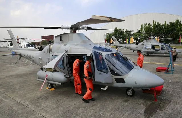 Members of the Philippine Air Force inspect one of the two AW-109E helicopters during a turnover ceremony at the Philippine Air Force (PAF) headquarters in Villamor Air Base in Pasay city, metro Manila August 17, 2015. The Philippines received 10 brand-new Bell-412EP and AW-109E helicopters from Canada and Italy to boost the air force's capabilities to provide close air support and air reconnaissance in counter-insurgency operations and transport for humanitarian assistance and disaster response, a Philippine Air Force official said. (Photo by Romeo Ranoco/Reuters)
