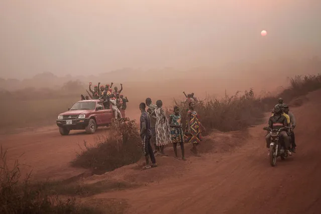 People celebrate as they drive cars and motorbikes for the arrival of former Central African Republic's President François Bozize in the Boeing district of Bangui, on December 21, 2019. The former president of the Central African Republic (CAR), Francois Bozize, has returned to the country, more than six years after he was forced from power and fled abroad, his party told AFP on December 16, 2019, in a claim rejected by the government. Bozize faces an international arrest warrant, initiated by the CAR in 2013, for crimes against humanity and incitement to genocide. (Photo by Florent Vergnes/AFP Photo)