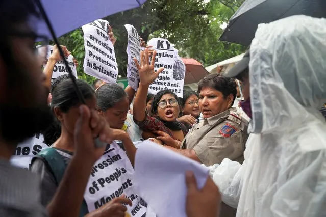 Police officers detain members of Krantikari Yuva Sangathan (KYS), a student organization, as they arrive to submit a memorandum at the United Nation's India office to protest against the raid on an anti-government protest camp and to show solidarity with the people of Sri Lanka, amid the country's economic crisis, in New Delhi, India, July 22, 2022. (Photo by Anushree Fadnavis/Reuters)