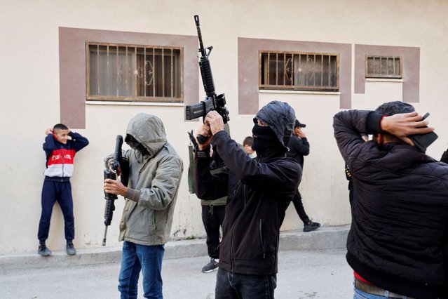 People react as gunmen fire into the air during the funeral of two Palestinians killed in an Israeli raid, in Yabad near Jenin in the Israeli-occupied West Bank on November 25, 2024. (Photo by Raneen Sawafta/Reuters)