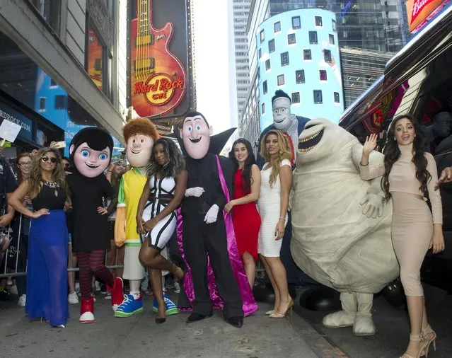 Ally Brooke, Normani Kordei, Lauren Jauregui, Dinah Jane Hansen and Camila Cabello, left to right, of Fifth Harmony, pose with characters from the movie “Hotel Transylvania 2” at Hard Rock Cafe New York, Thursday, August 27, 2015, to reveal the music video for their song, “I'm In Love with a Monster”. (Photo by Diane Bondareff/Invision for Hard Rock International/AP Images)